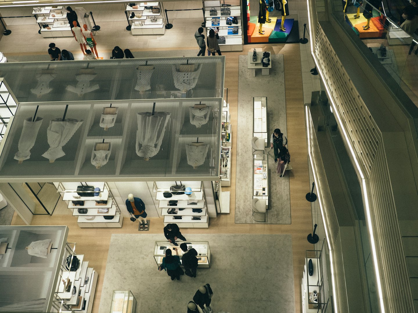 Customers browse merchandise in a multi-level modern retail store.