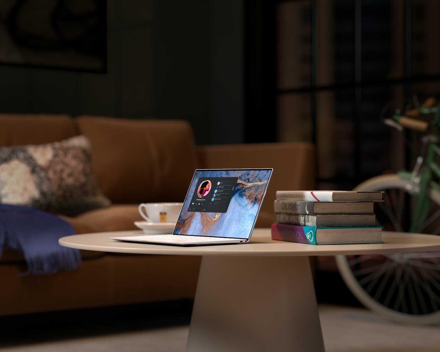 Laptop on a coffee table with books and a blanket.